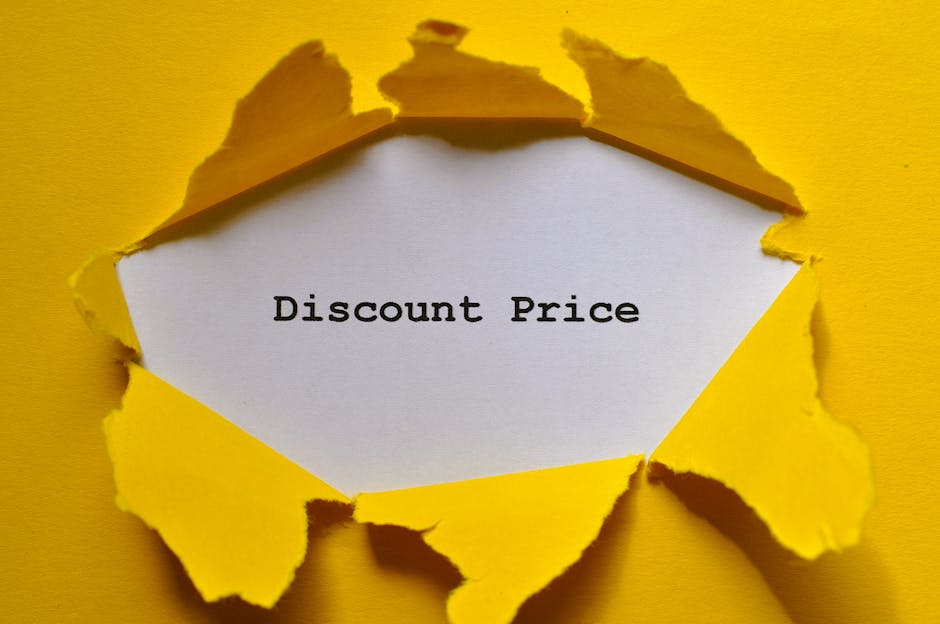 A bright yellow piece of paper has been torn open in the shape of an irregular hole, revealing a white inner surface. On this inner surface, the words 'Discount Price' are printed in black typewriter-